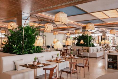 a rendering of a restaurant with tables and chairs at ME Marbella by Meliá in Marbella
