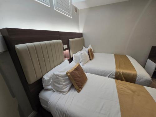 two beds sitting next to each other in a hotel room at Double bedroom studios in Dublin