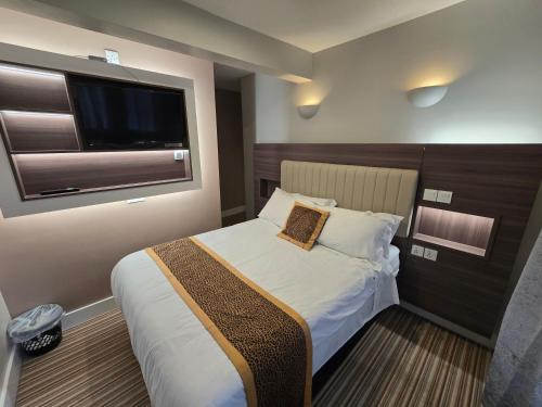 a hotel room with a bed and a television at Double bedroom studios in Dublin