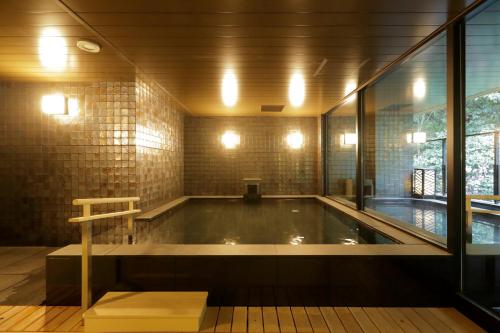 an empty swimming pool in a room with a window at Tsukino Yado Sara in Hakone