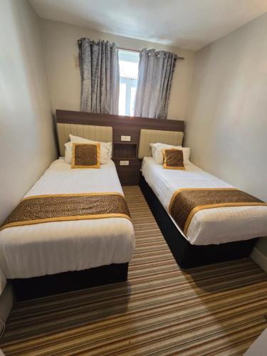 a room with two beds in a room at Double bedroom studios in Dublin
