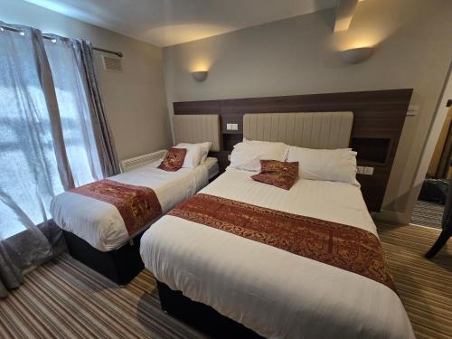 a hotel room with two beds and a window at Double bedroom studios in Dublin