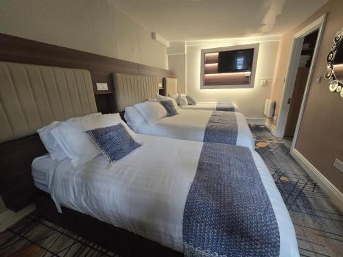 a hotel room with two beds and a window at Double bedroom studios in Dublin