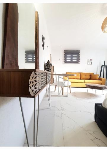 a living room with a couch and a mirror at Olea Luxury Suites in Asprovalta