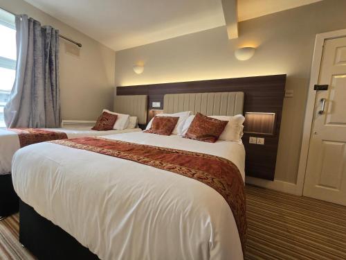 a hotel room with two beds and a window at KGT House in Dublin