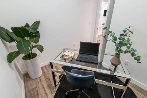 an office with a glass desk with a laptop on it at 2BR Miami Condo - Near Marina & Attractions in Miami