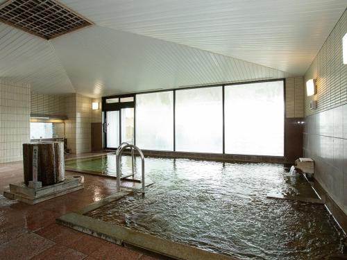 a room with a pool of water in a building at Nangoku Hotel in Minamiboso