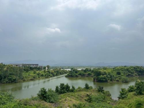 a view of a river with trees in the distance at Kalyan luxury rooms in Garudeshwar