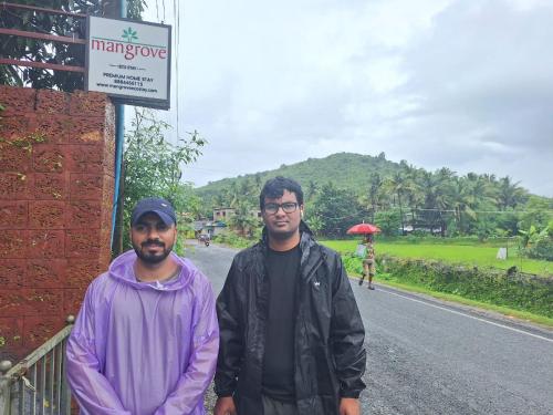 two men standing on the side of a road at Mangrove Ecostay in Gokarna