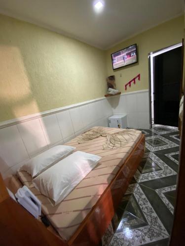 a bedroom with a large bed in a room at Hotel jardim paulista in São Paulo
