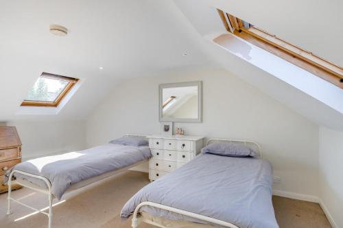 two beds in a white room with a window at 3 Bed in Aldeburgh oc-f32700 in Aldeburgh