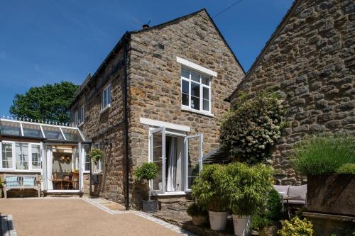 an exterior view of a stone house at 2 Bed in Baslow oc-h32721 in Baslow