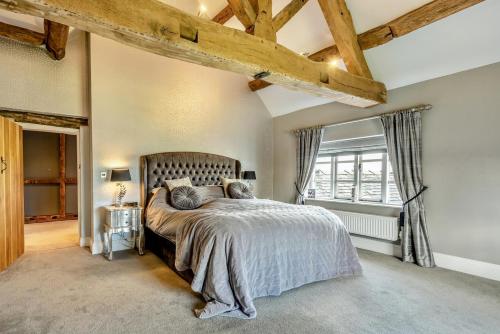 a bedroom with a large bed and a window at 8 Bed in Standon oc-w32745 in Eccleshall