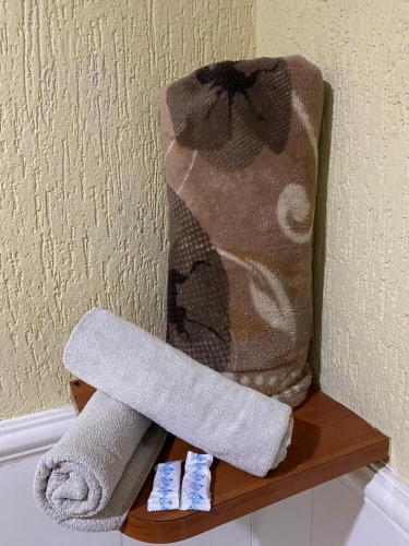 a couple of towels on a shelf in a bathroom at Hotel jardim paulista in São Paulo