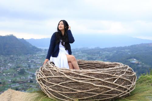 a woman sitting on top of a nest at Pinggan Skyline in Baturaja