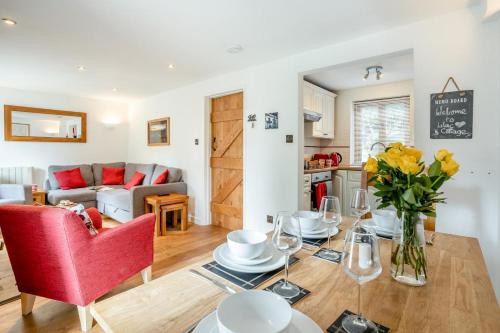 a living room with a table and a red chair at 2 Bed in Govilon oc-u32754 in Govilon