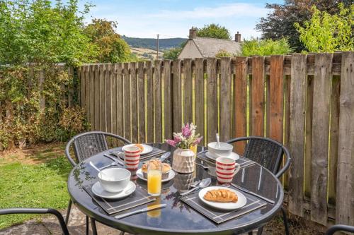 a table with food and drinks on it in a backyard at 2 Bed in Govilon oc-u32754 in Govilon