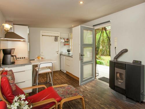 a living room with a kitchen and a living room with a fireplace at Fishing Chalet, Opglabbeek in Oudsbergen 