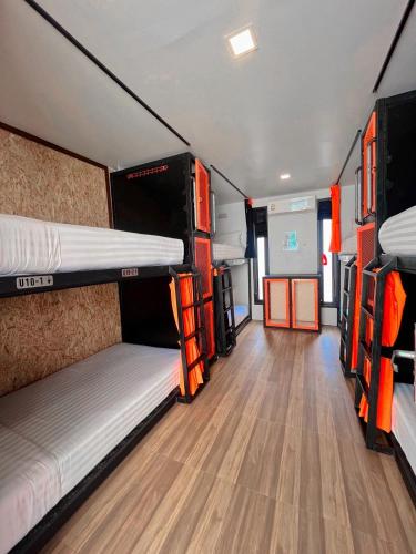 a room with two bunk beds in a van at Ubox samui hostel & Bungalow - Chaweng beach in Chaweng