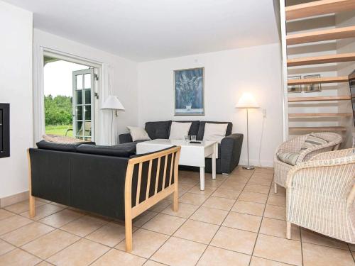 a living room with a couch and a table at 8 person holiday home in Gjern-By Traum in Gjern