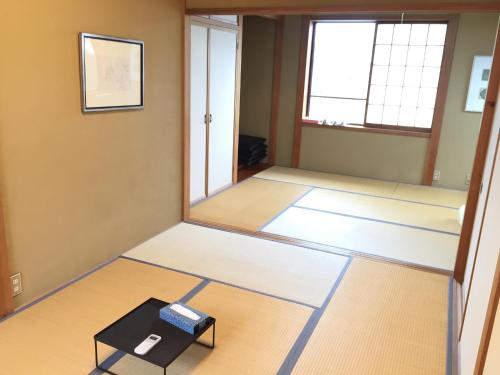 a room being remodeled with a mirror and a box at Toolate Guesthouse Toyama in Toyama