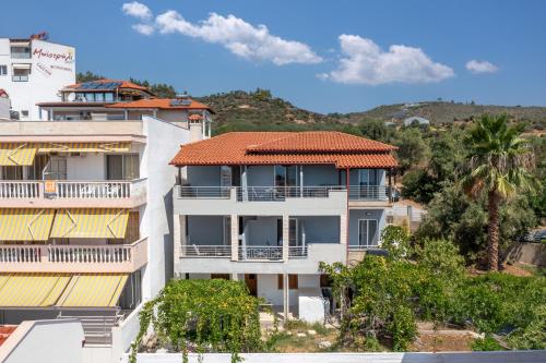 an apartment building with an orange roof at BLUE HORIZON SARTI Oe in Sarti