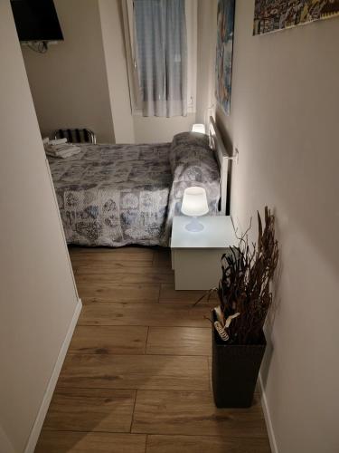 a bedroom with a bed and a table with a plant at Pontassieve Guest House centro storico camera con bagno 20 minuti da Firenze in Pontassieve