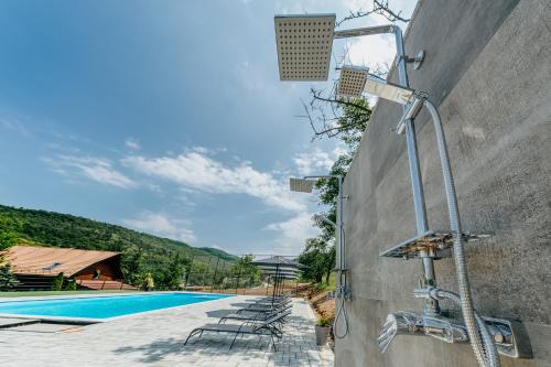 a security system on a wall next to a swimming pool at Pensiunea Patakparti 2 in Praid