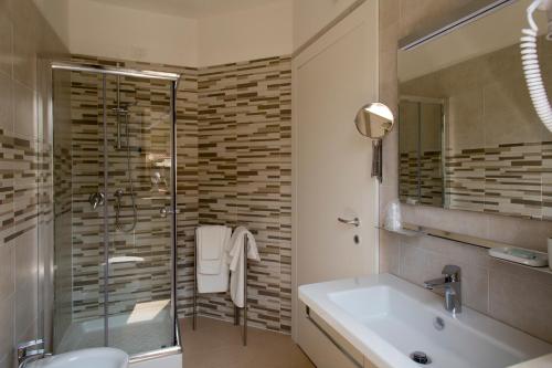 uma casa de banho com um chuveiro, um lavatório e uma banheira em B&B Olganna em Vasto