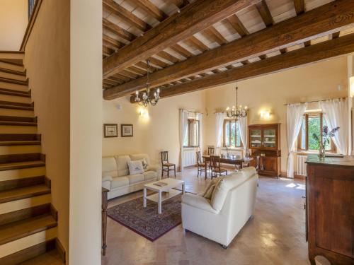 a living room with a white couch and a table at Beautiful Villa in Belforte all'Isauro with Swimming Pool in Belforte allʼIsauro