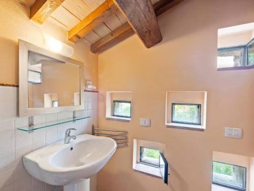 a bathroom with a sink and a mirror at Beautiful Villa in Belforte all'Isauro with Swimming Pool in Belforte allʼIsauro