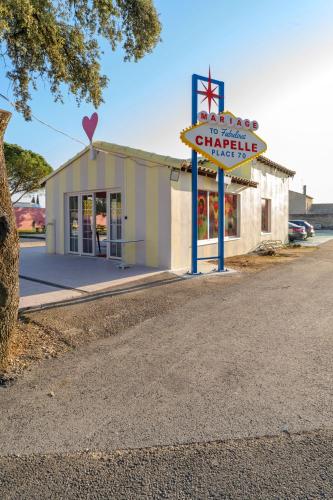 a building with a sign in front of a dealership at greet hôtel Pont du Gard - Route d'Avignon in Estézargues