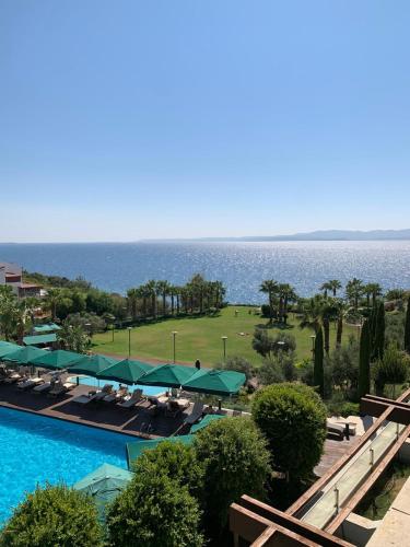 a view of a resort with a swimming pool and the ocean at ON'LIVE HOTEL in Cesme