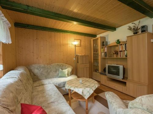 a living room with two couches and a tv at Welcoming bungalows in Neustadt in Neustadt/Harz