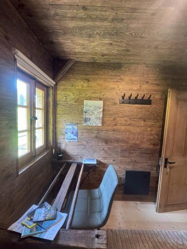 a wooden room with a bench and a window at La Chotte du Musher in Champéry