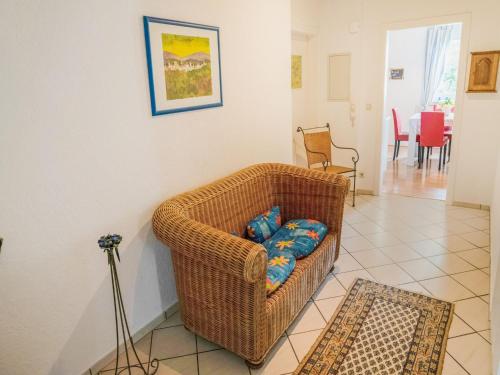 a wicker chair sitting in a living room at Luxurious Apartment in Medebach near public pool in Medebach