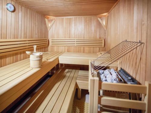 a sauna with a bench and a clock in it at Attractive holiday home in Kaltenbach on the ski-slope in Stumm