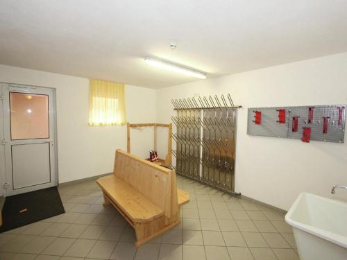 a room with a bench in the middle of a room at Attractive holiday home in Kaltenbach on the ski-slope in Stumm