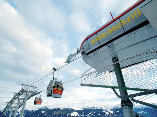 a ski lift with two cars on a mountain at Attractive holiday home in Kaltenbach on the ski-slope in Stumm