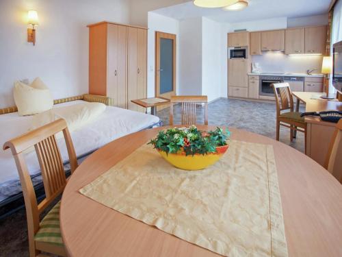 a room with a table and a bed and a kitchen at Attractive holiday home in Kaltenbach on the ski-slope in Stumm