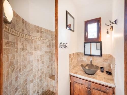 a bathroom with a sink and a shower at Detached holiday home in Chassiers with pool in Chassiers