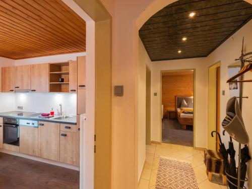 an open kitchen with wooden cabinets and a dining room at Modern Apartment in Kitzbuhel near Ski Area in Kitzbühel