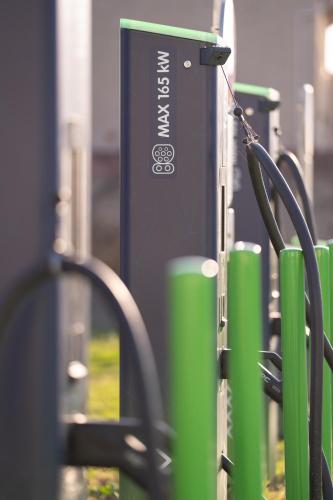 a gas station with green poles and a charger at greet hôtel Pont du Gard - Route d'Avignon in Estézargues