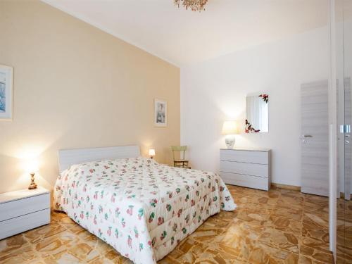 a white bedroom with a bed and two night stands at Holiday Home near Florence with Garden in Borgo San Lorenzo