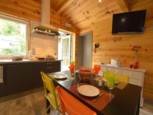 a kitchen and dining room with a table and chairs at Scenic chalet in Vieuxville with terrace in Vieuxville