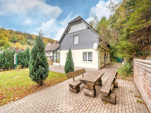 a picnic bench in front of a house at Deluxe Holiday Home in Brilon-Wald near Ski Area in Brilon
