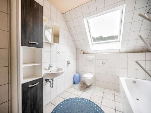a bathroom with a sink and a toilet and a window at Deluxe Holiday Home in Brilon-Wald near Ski Area in Brilon