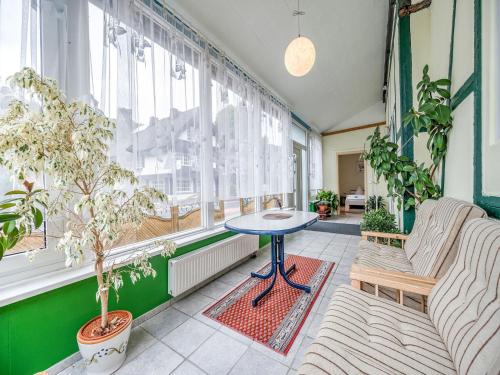 a room with a table and chairs and windows at Deluxe Holiday Home in Brilon-Wald near Ski Area in Brilon
