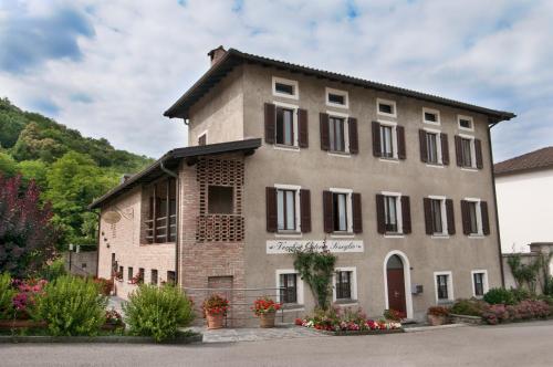 a large brick building with black shuttered windows at Vecchia Osteria Seseglio in Chiasso