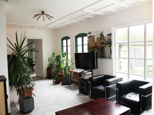 a living room with black chairs and a flat screen tv at Gorgeous apartment in Neuburg with terrace in Neuburg-Steinhausen